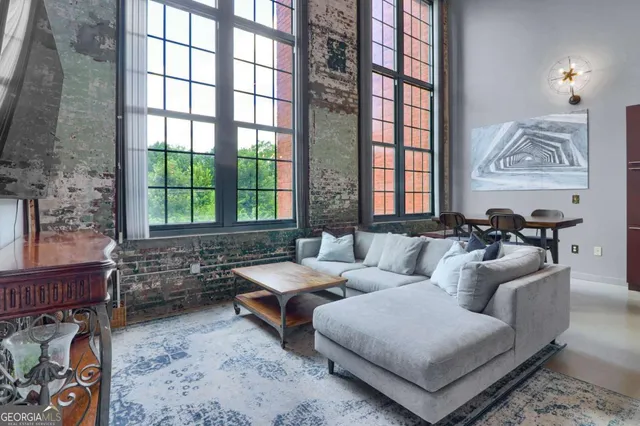 a living room with furniture and windows