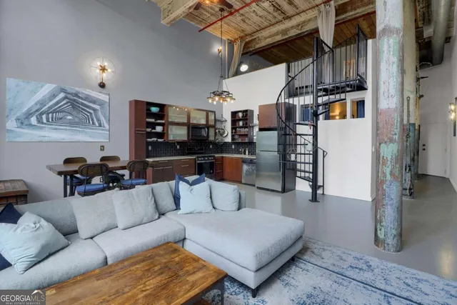 a living room with furniture and a kitchen