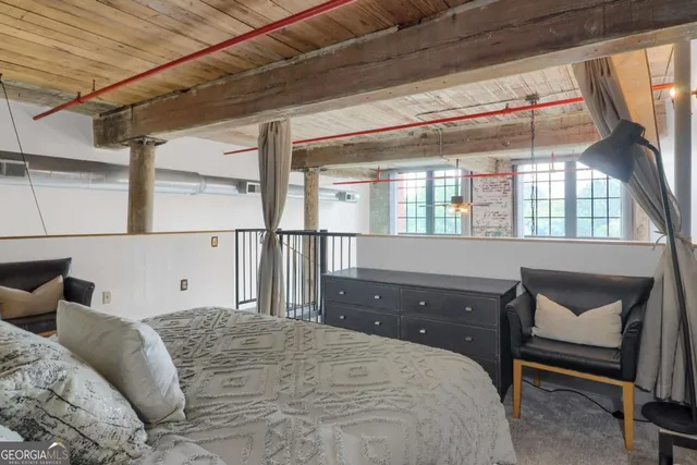 a bedroom with a large bed and a window