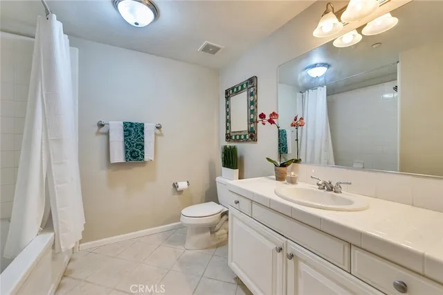 a bathroom with a sink vanity and a mirror