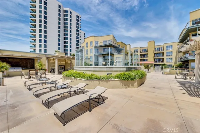 a view of a swimming pool with outdoor seating and plants