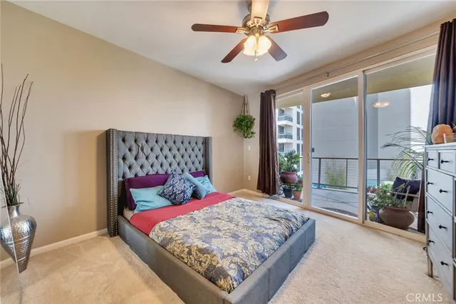 a bedroom with a large bed and a chandelier