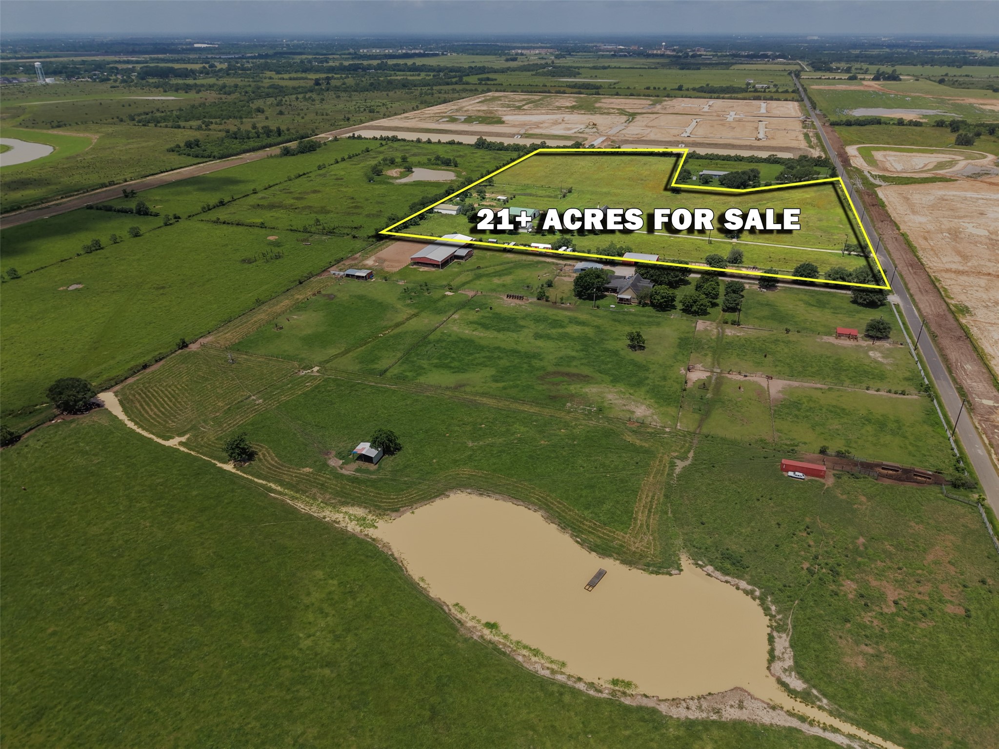 33737 Cameron Road Waller, TX 77484 - Photo 13 of 24 This aerial view showcases a spacious rural property with lush green fields, multiple structures including barns and outbuilding. The expansive land offers privacy and ample space for agricultural or recreational use, set in a serene countryside setting.
