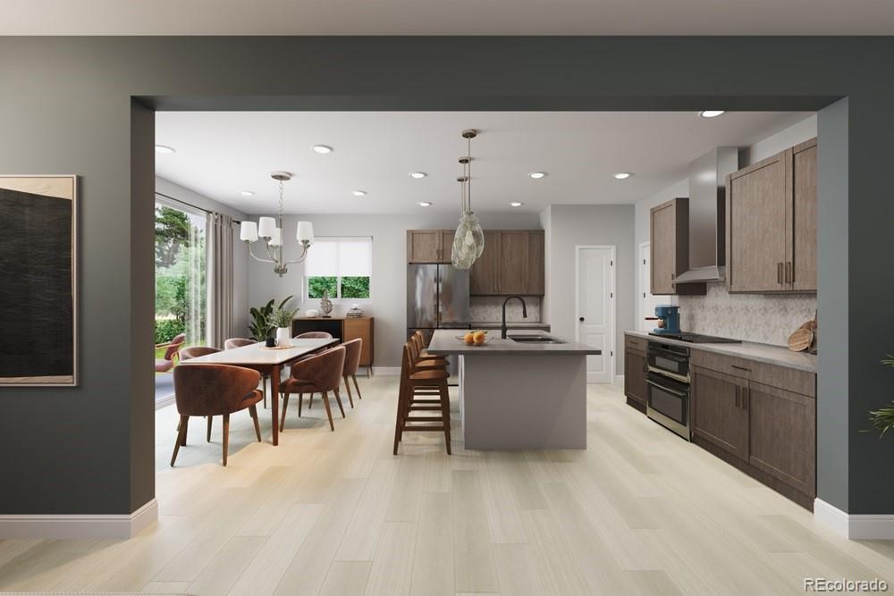 9173 Violet Way Arvada, CO 80007 - Photo 11 of 32 a kitchen with a sink stainless steel appliances and cabinets