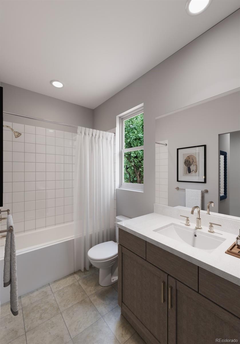 9173 Violet Way Arvada, CO 80007 - Photo 21 of 32 a bathroom with a sink a toilet and shower