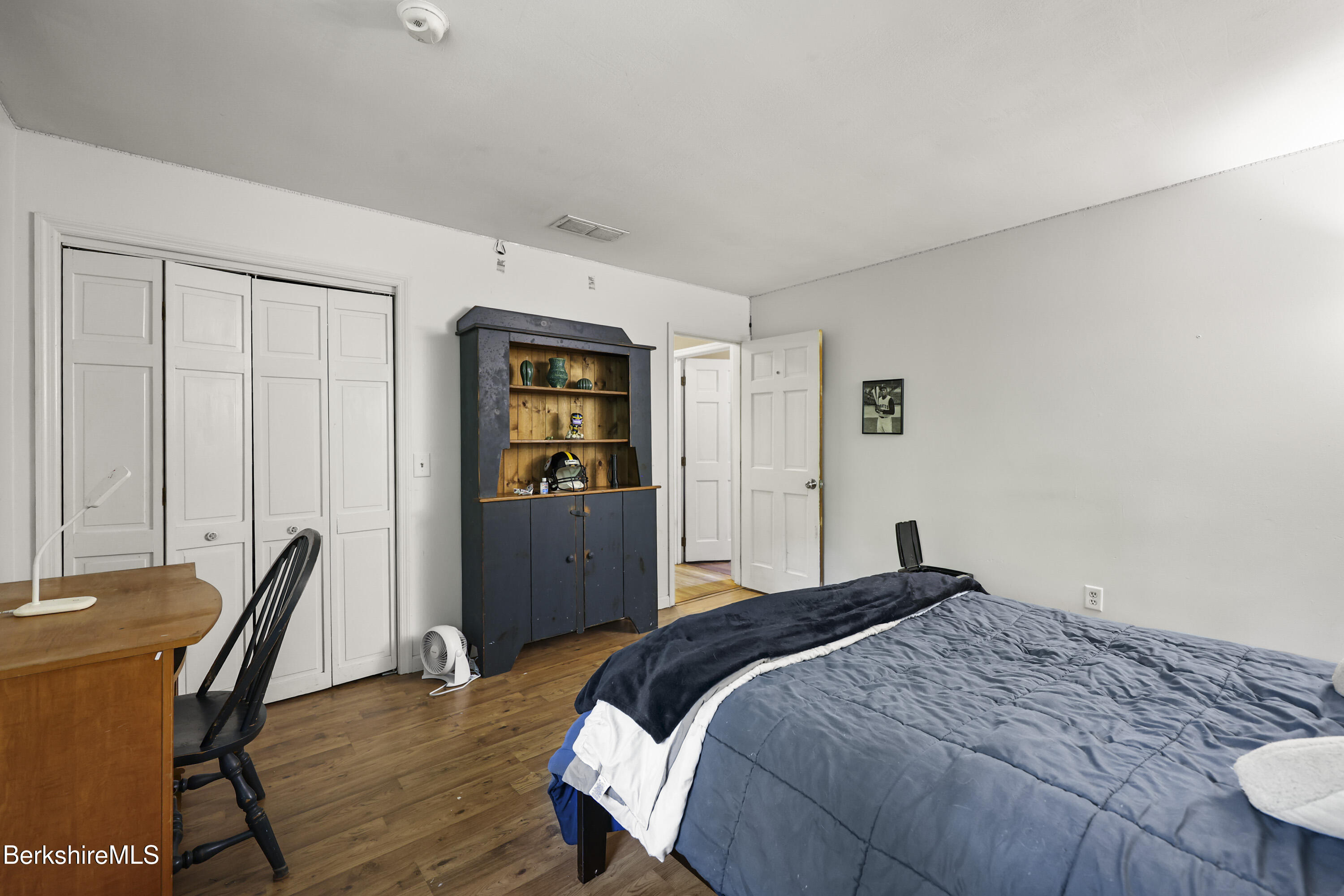 1592 County Road Sheffield, MA 01230 - Photo 20 of 32 a bedroom with a bed and a table