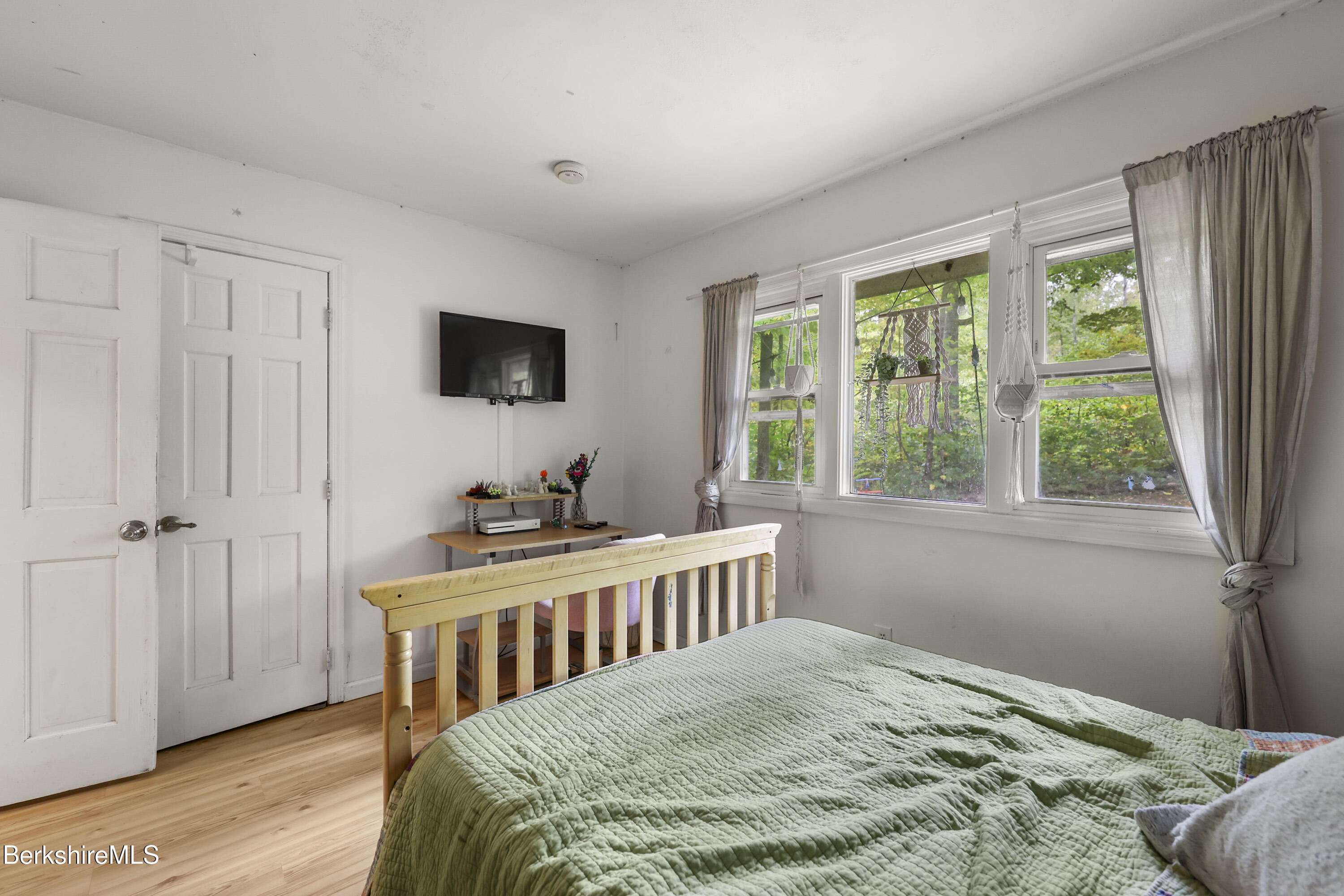 1592 County Road Sheffield, MA 01230 - Photo 22 of 32 a bedroom with a bed and a flat screen tv