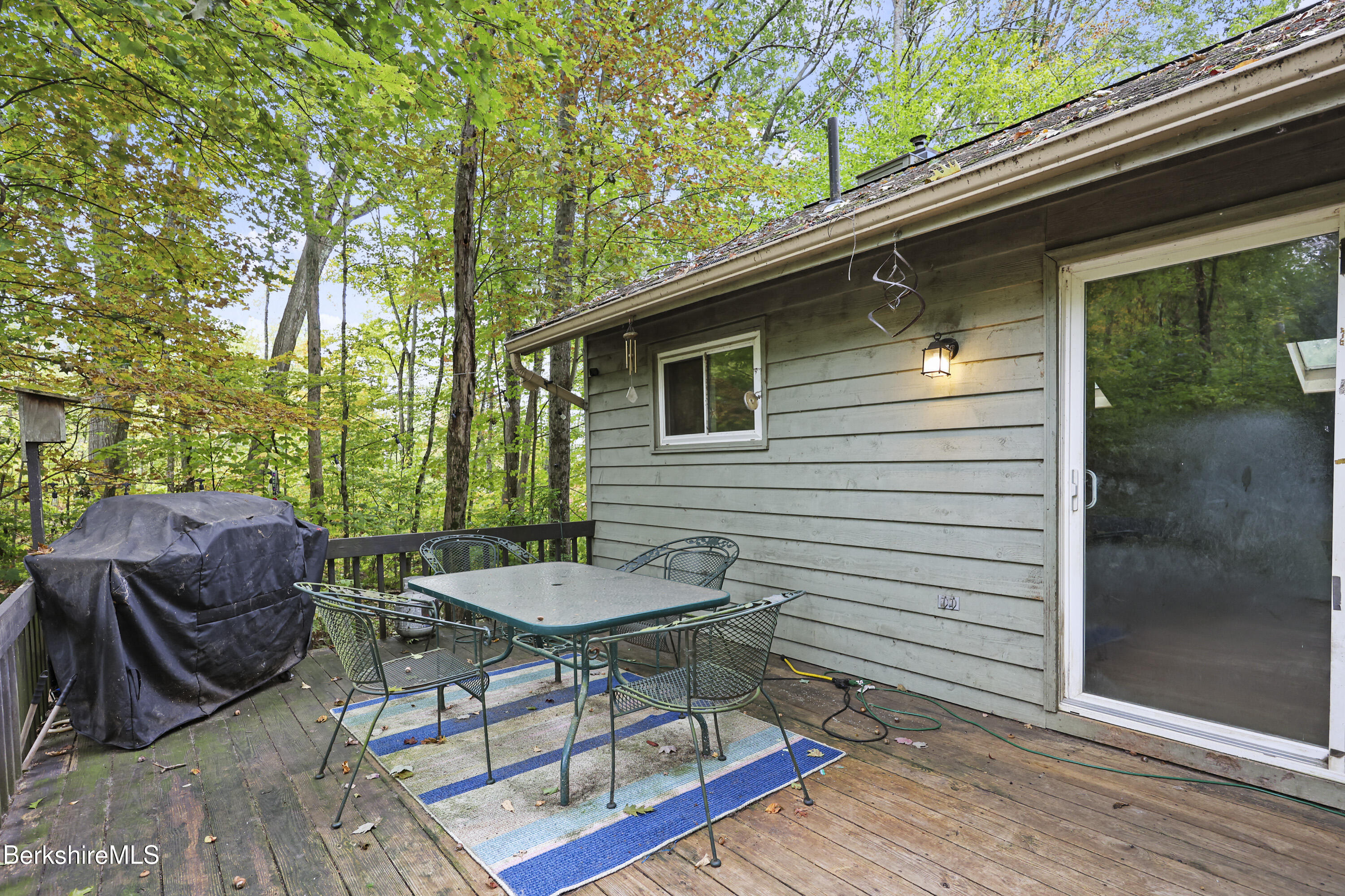 1592 County Road Sheffield, MA 01230 - Photo 29 of 32 a view of a patio with table and chairs with wooden floor and fence