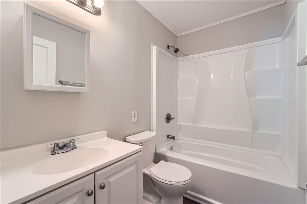 2275 Old Spring Road Smyrna, GA 30080 - Photo 20 of 28 a bathroom with a sink toilet vanity and shower
