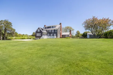 a view of a building with yard in front of it