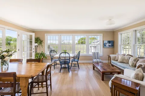 a view of a dining room with furniture window and wooden floor
