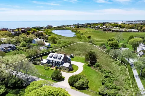 an aerial view of a houses with a lake view