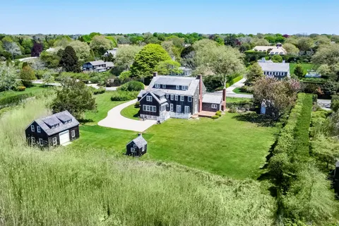 an aerial view of a house with garden space and street view