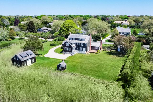 an aerial view of a house with garden space and street view