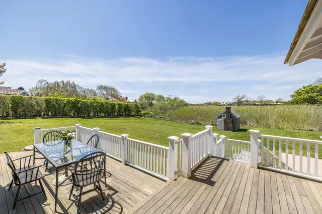 a view of a lake with couches in the patio