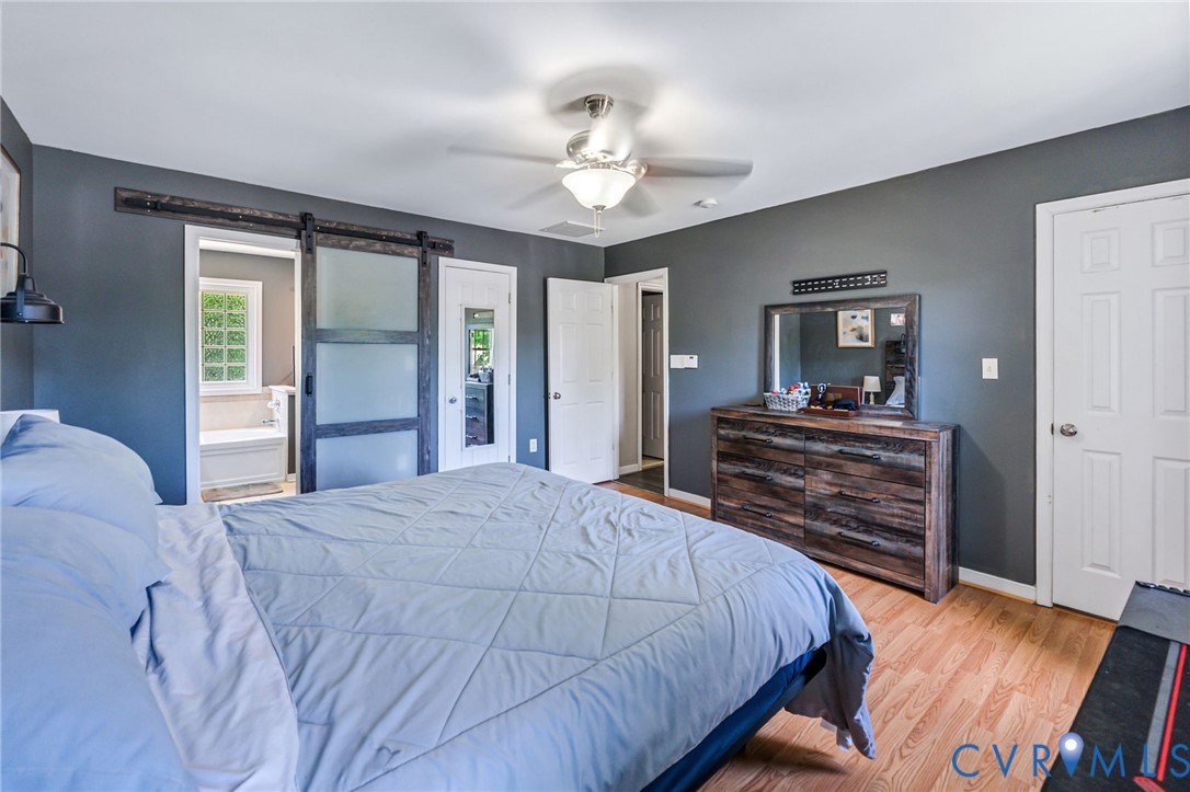 3218 Rimswell Court Midlothian, VA 23112 - Photo 26 of 32 Bedroom featuring a barn door, wood finished floor