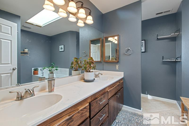 3920 West 7th Street Reno, NV 89503 - Photo 13 of 20 a bathroom with a sink double vanity and a mirror