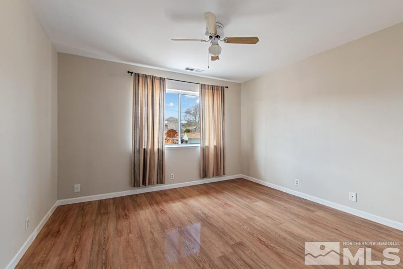 3920 West 7th Street Reno, NV 89503 - Photo 17 of 20 wooden floor in an empty room with a window