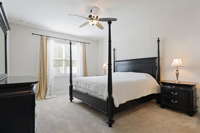 a bedroom with a bed next to a window