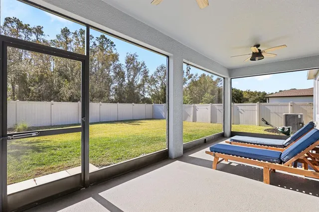 a room with pool table and windows