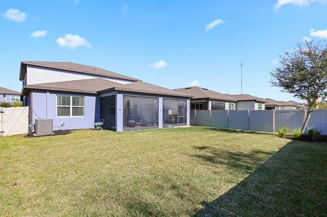 a front view of a house with a garden and trees