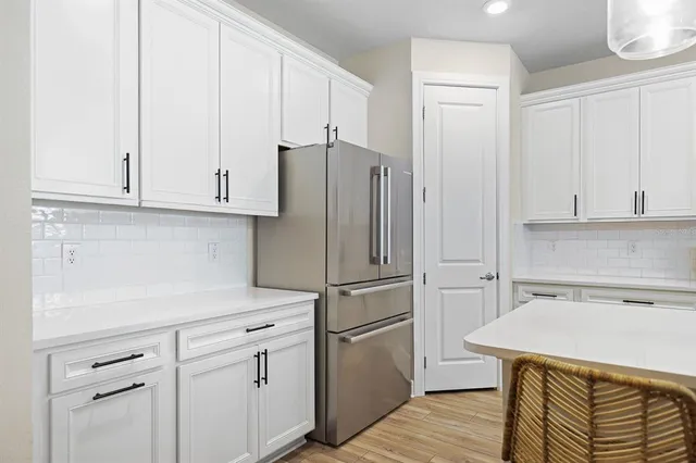 a kitchen with a white cabinets and white appliances