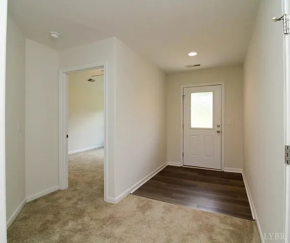 an empty room with closet and fan