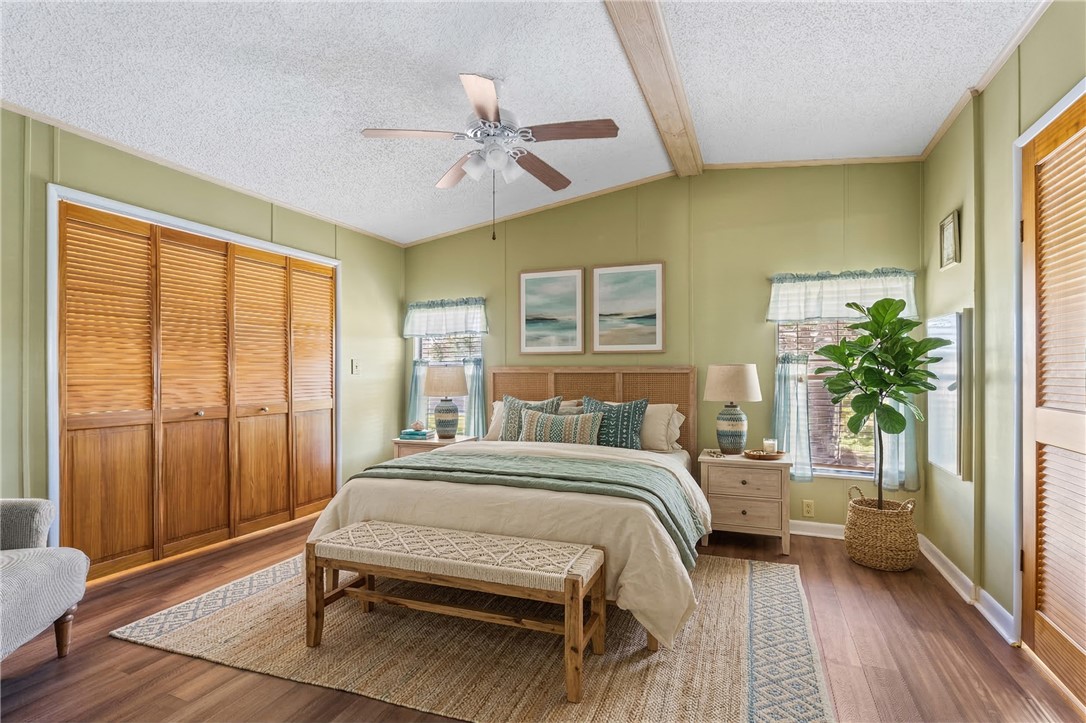 7635 Blackhawk Road Micco, FL 32976 - Photo 12 of 30 a bedroom with a bed and a chandelier