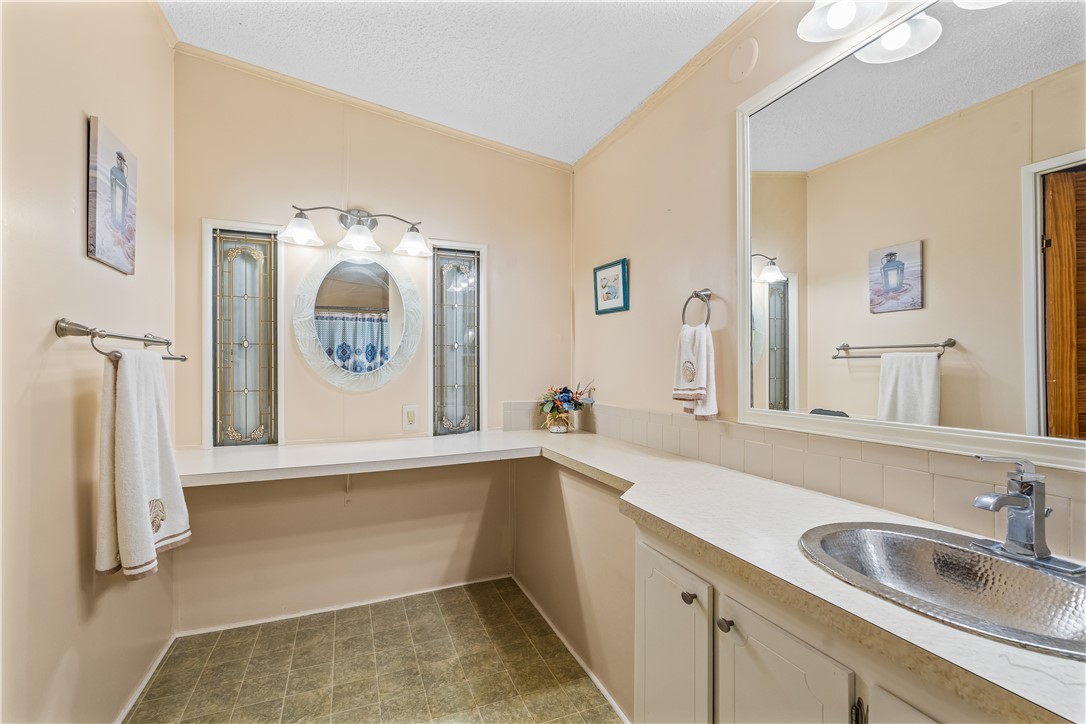 7635 Blackhawk Road Micco, FL 32976 - Photo 15 of 30 a bathroom with a sink and mirror with bathtub