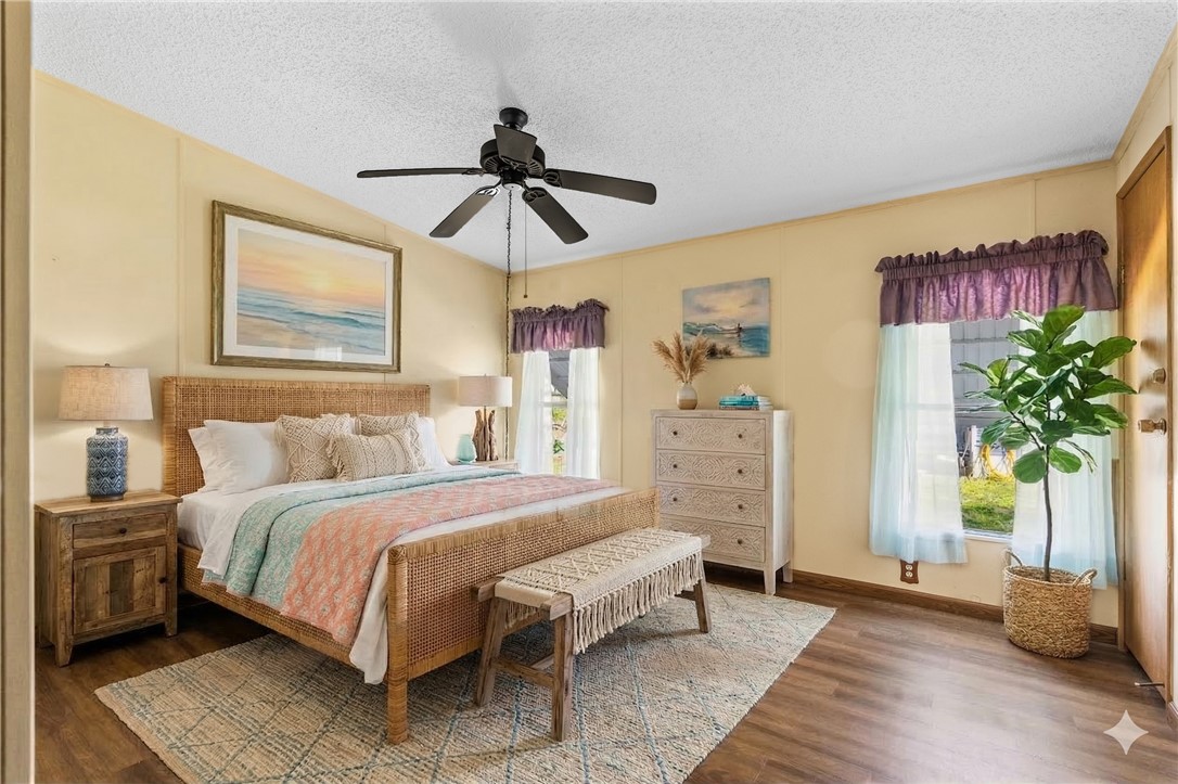 7635 Blackhawk Road Micco, FL 32976 - Photo 16 of 30 a bedroom with a bed dresser and a window