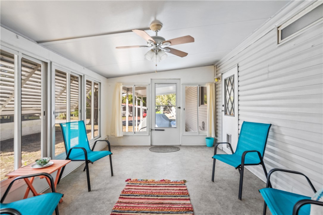 7635 Blackhawk Road Micco, FL 32976 - Photo 20 of 30 a living room with furniture and floor to ceiling windows