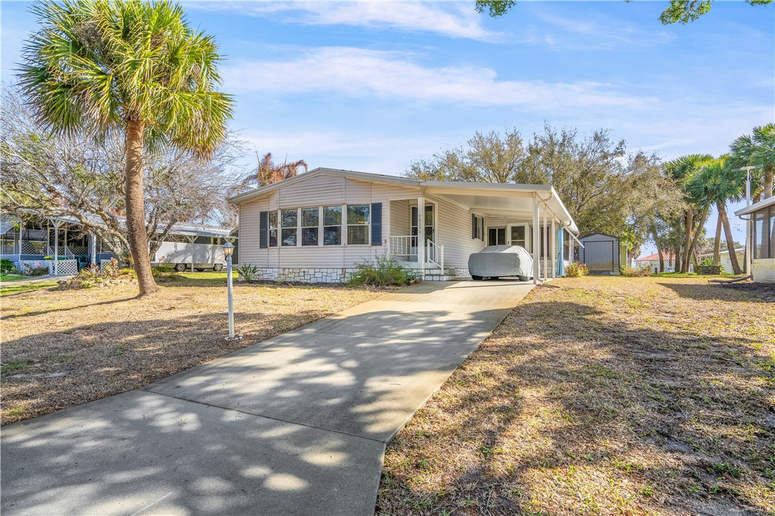 7635 Blackhawk Road Micco, FL 32976 - Photo 2 of 30 a front view of a house with a yard