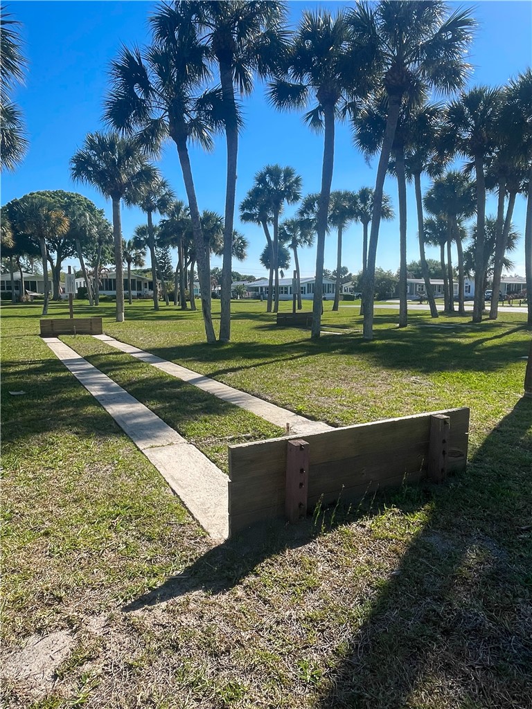 7635 Blackhawk Road Micco, FL 32976 - Photo 27 of 30 a view of a swimming pool with a yard and palm trees