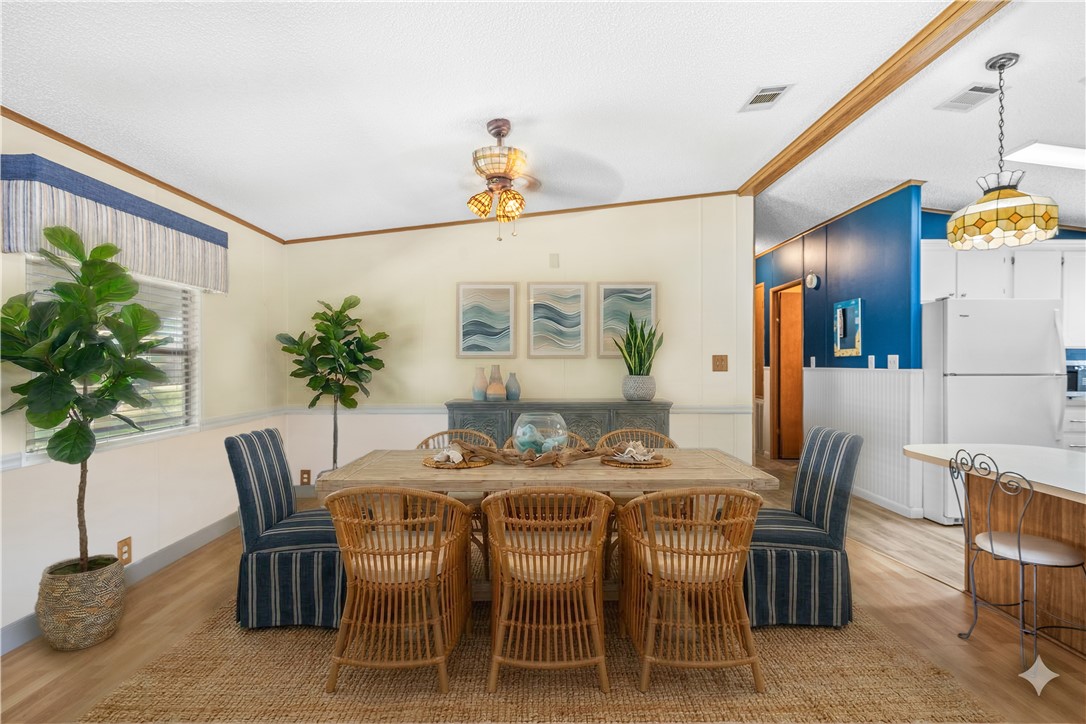 7635 Blackhawk Road Micco, FL 32976 - Photo 3 of 30 a dining room with furniture potted plants and wooden floor