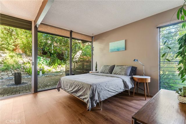 a bed sitting in a bedroom next to a window