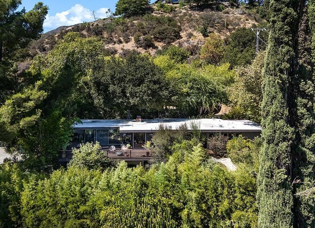 a view of a house with a yard and sitting area