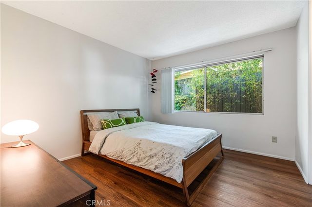 a bed sitting in a bedroom next to a window