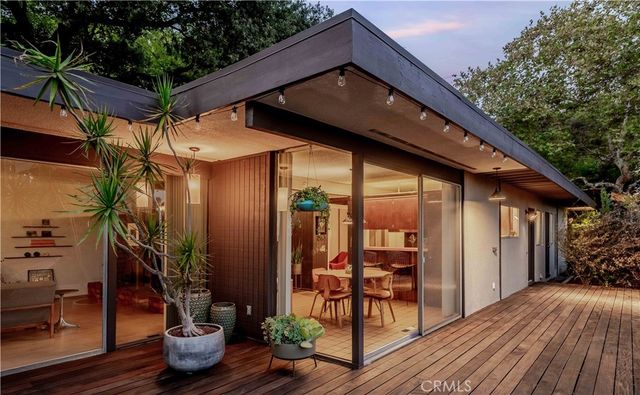 a view of a house with backyard and sitting area