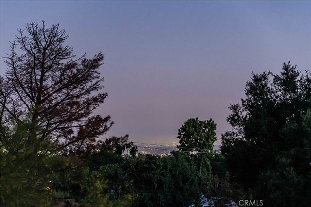 a view of a house with a tree