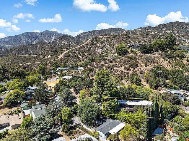 a view of a house with a yard and sitting area