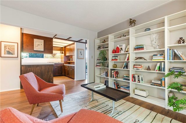 a living room with furniture a rug and a book shelf