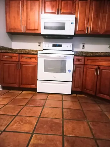 a kitchen with a stove and cabinets