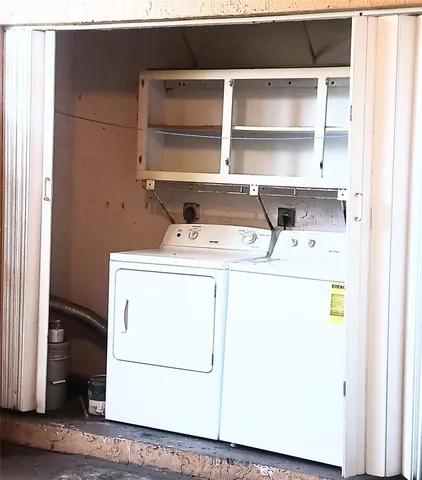 a view of a house with a yard and a large tree