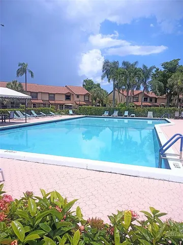 a view of a swimming pool with an outdoor seating