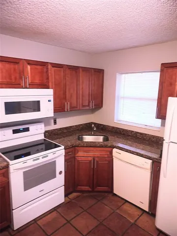 a kitchen with a stove top oven sink and cabinets