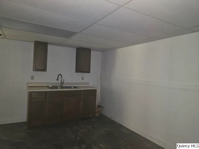 a kitchen with sink and cabinets