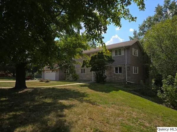 a front view of a house with a yard garage and outdoor seating