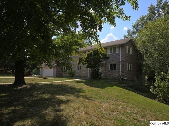 1797 East Co Road 1540 Carthage, IL 62321 - Photo 31 of 36 a front view of a house with a yard garage and outdoor seating