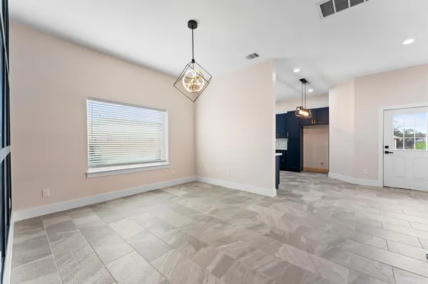 a view of an empty room with a chandelier