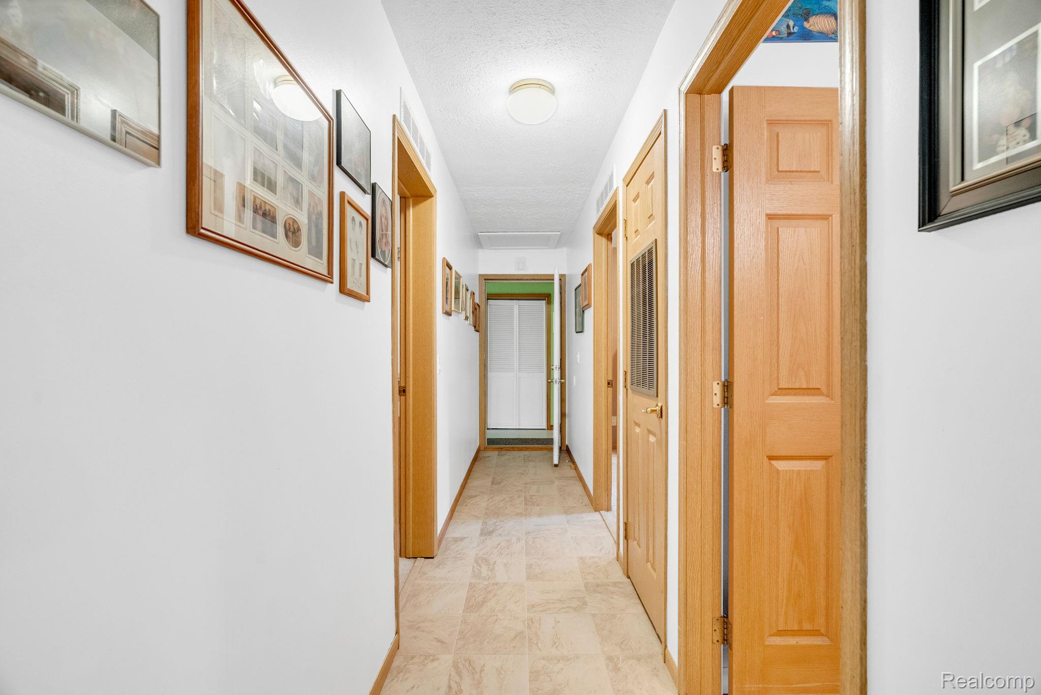 6562 Custer Road Port Sanilac, MI 48469 - Photo 28 of 56 Corridor with a textured ceiling and baseboards